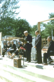 man giving speech on a stage at a podium