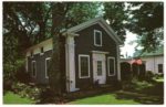 exterior of brown house with tree in front