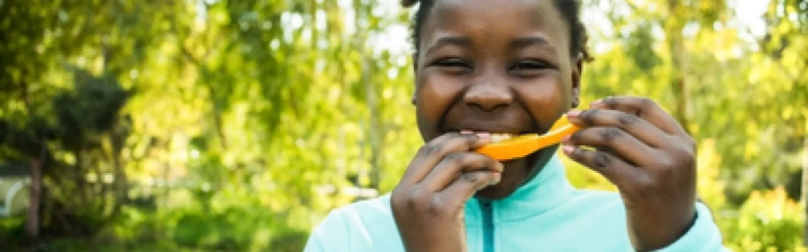 child eating orange